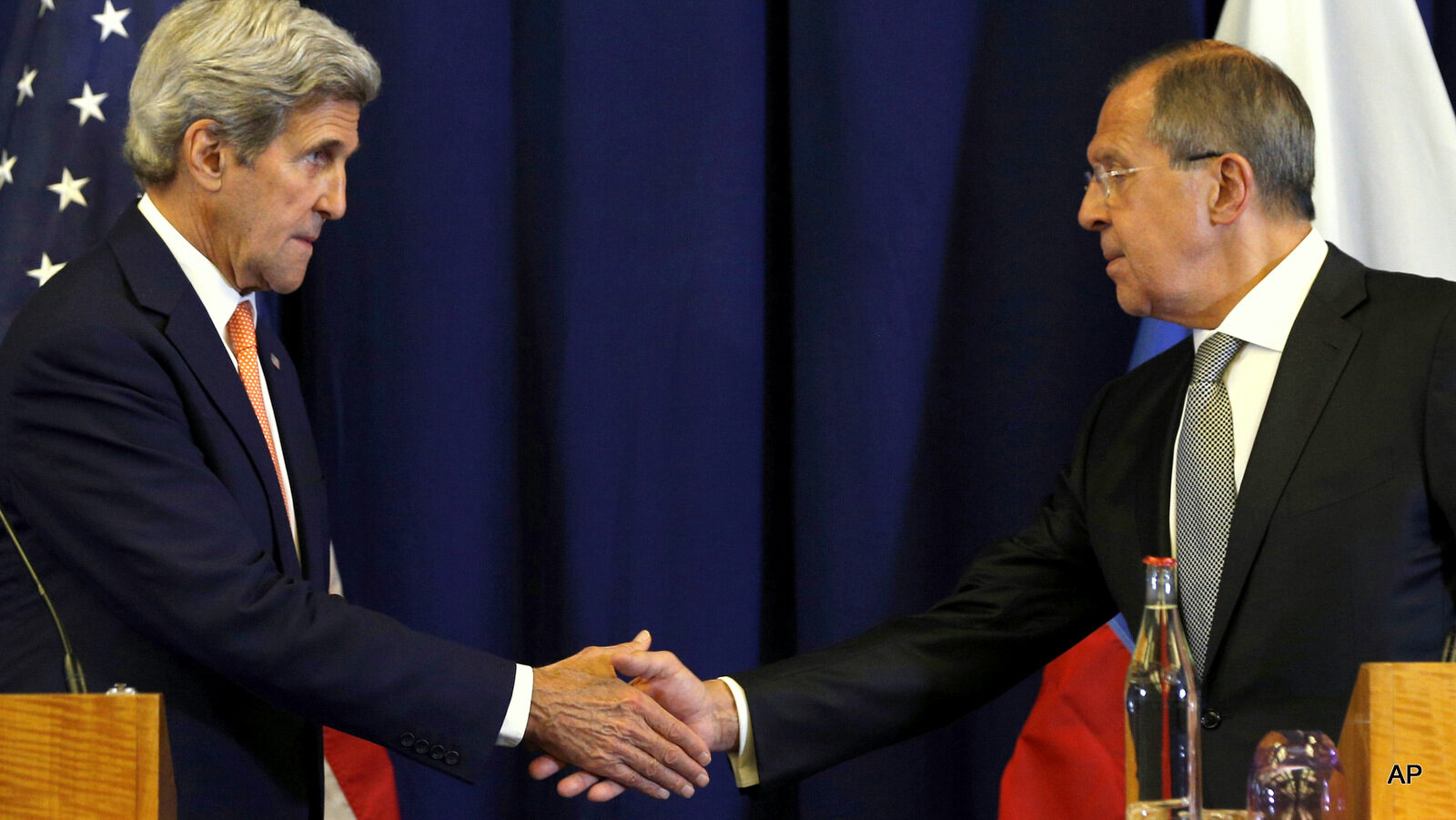 Secretary of State John Kerry, left, and Russian Foreign Minister Sergei Lavrov shakes hands at the conclusion of a news conference following their meeting to discuss the crisis in Syria, in Geneva, Switzerland.