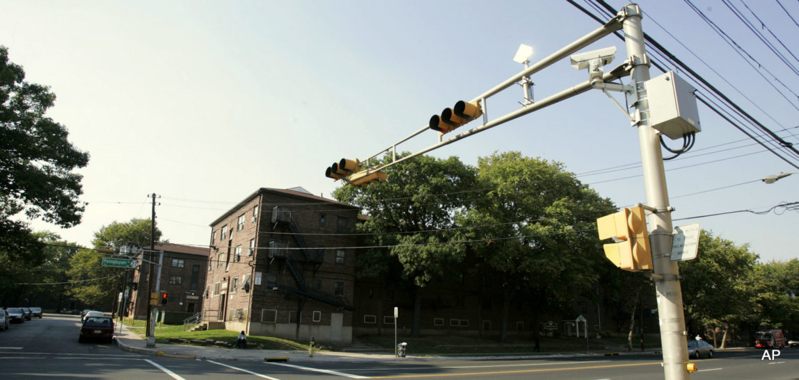 A surveillance camera is seen near the top of a traffic light pole in Newark, N.J., Sept. 21, 2007.
