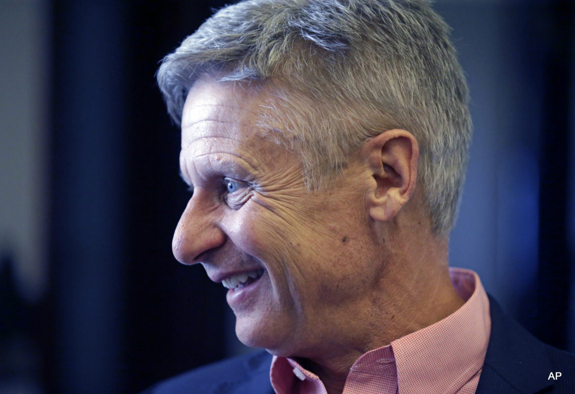 Libertarian presidential candidate, former New Mexico Gov. Gary Johnson speak with legislators at the Utah State Capitol in Salt Lake City.