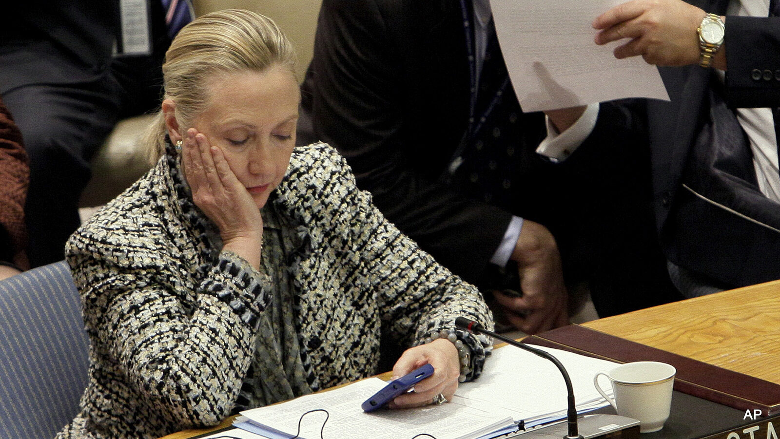 Secretary of State Hillary Clinton checks her mobile phone after her address to the Security Council at United Nations headquarters, March 12, 2012.