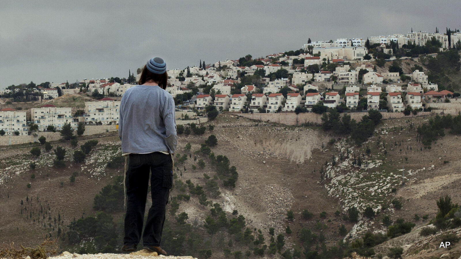 A Jewish settler looks at the West bank settlement of Maaleh Adumim, from the E-1 area on the eastern outskirts of Jerusalem.