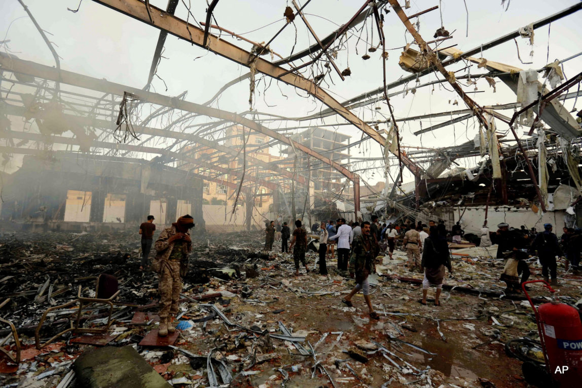 People inspect the aftermath of a Saudi-led coalition airstrike on a funeral hall in Sanaa, Yemen, Saturday, Oct. 8, 2016.