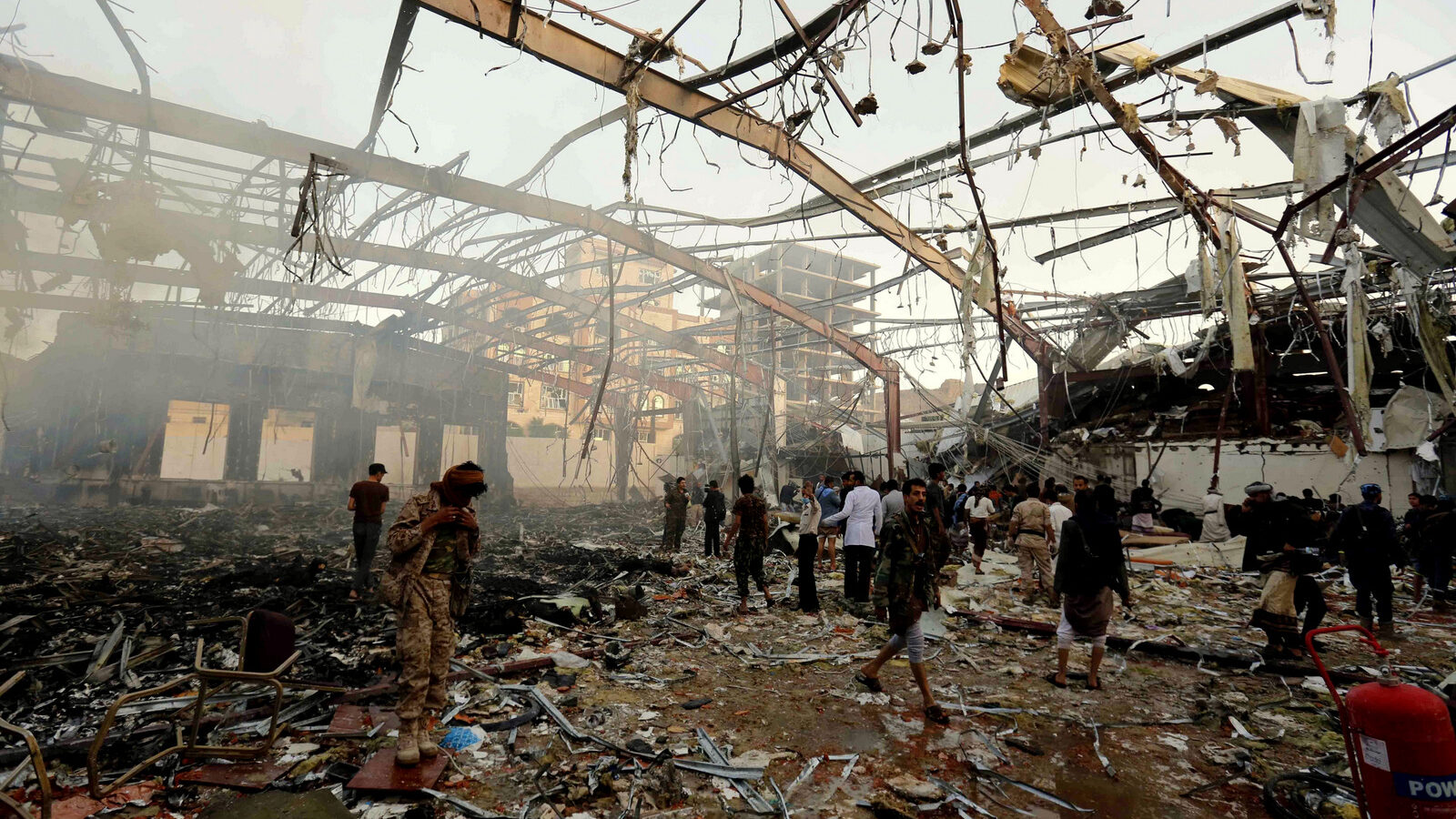 People inspect the aftermath of a Saudi-led coalition airstrike on a funeral hall in Sanaa, Yemen, Saturday, Oct. 8, 2016.