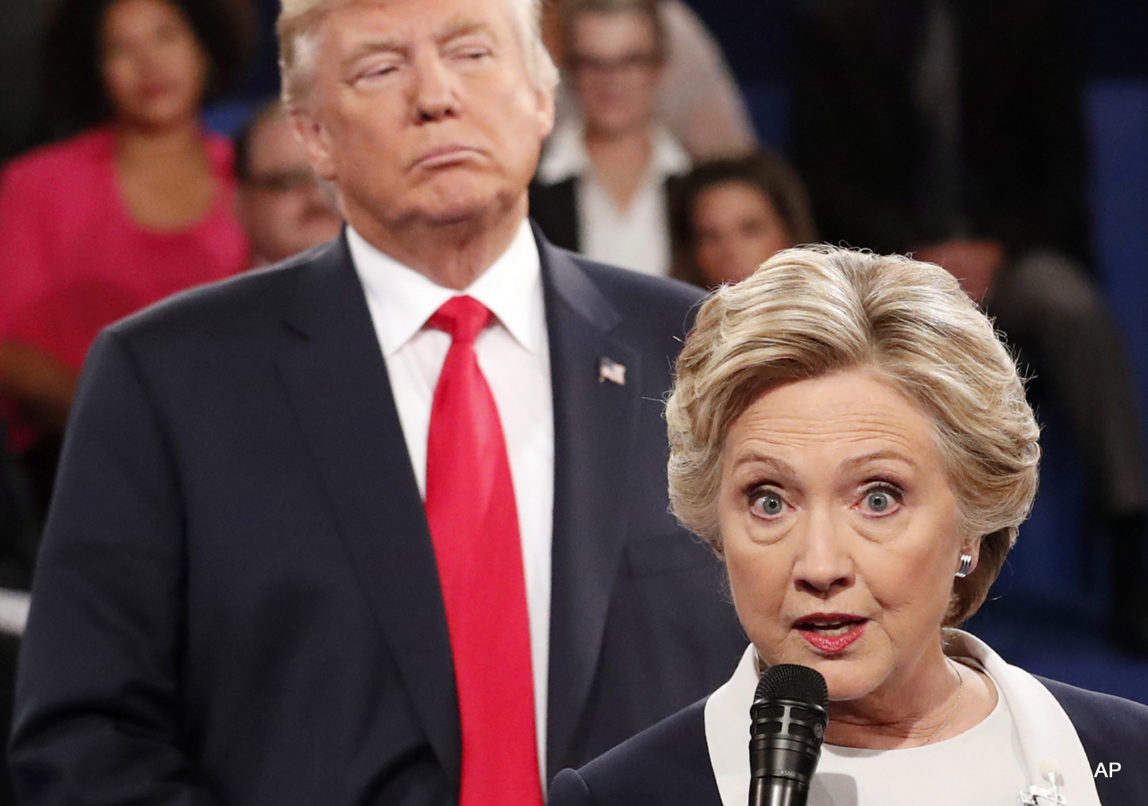 Democratic presidential nominee Hillary Clinton, right, speaks as Republican presidential nominee Donald Trump listens during the second presidential debate at Washington University in St. Louis, Sunday, Oct. 9, 2016.