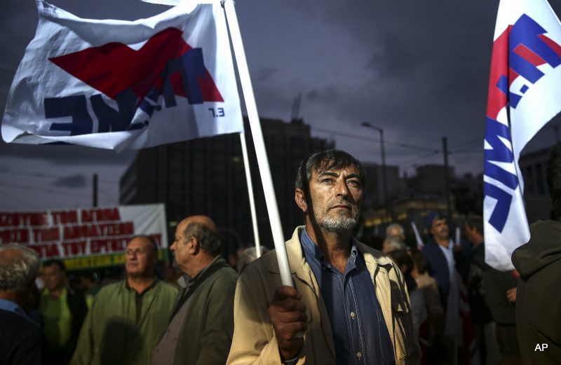 A supporter of the communist-affiliated union PAME takes part in an anti-austerity rally in front of the parliament in Athens, Monday, Oct. 17, 2016.