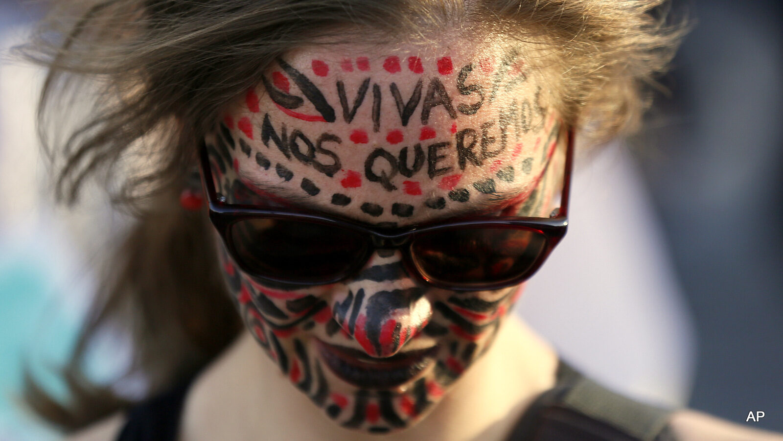 A woman with her face painted protests against gender violence in Mexico City, Wednesday, Oct. 19, 2016. Women across Latin America participated in protests in response to the shocking rape and killing of a teenage girl on Oct. 8 in Argentina.