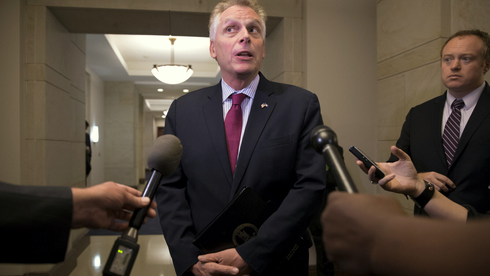 Virginia Gov. Terry McAuliffe speaks with reporters on Capitol Hill in Washington. McAuliffe helped fund the failed state Senate campaign of the FBI official’s wife who later go on to clear investigate Hillary Clinton's use of a private email server.