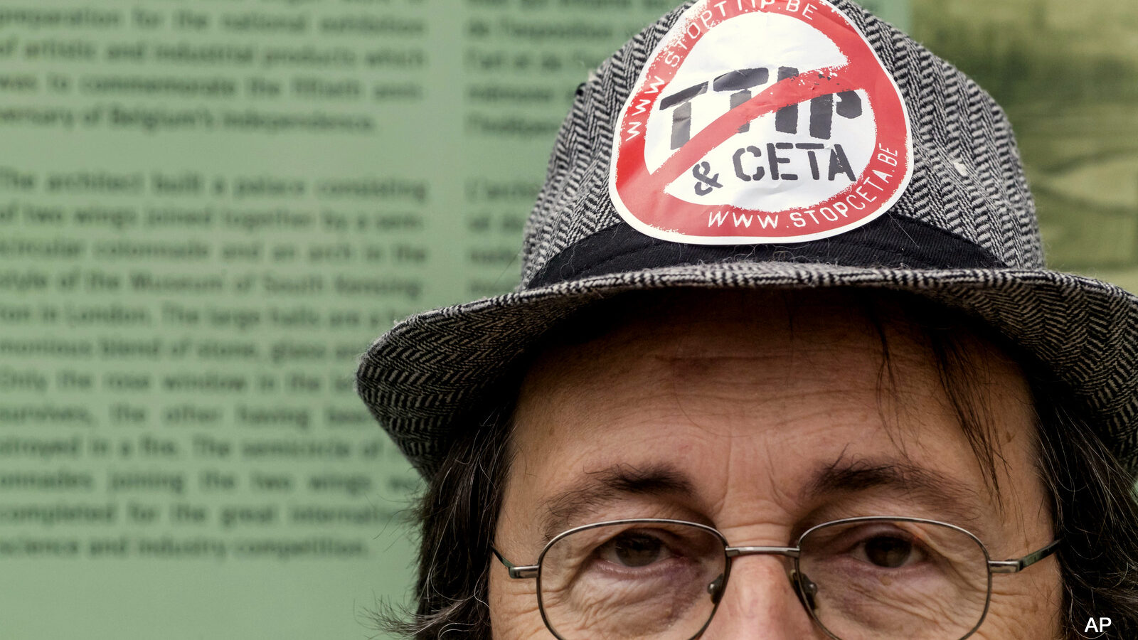 A man protests against international trade agreements TTIP and CETA in front of EU headquarters in Brussels on Thursday, Oct. 27, 2016.