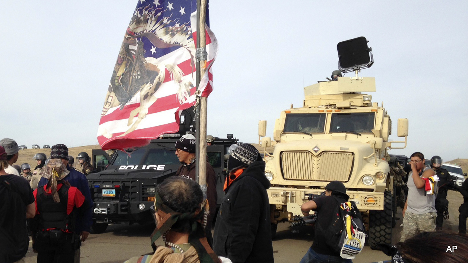 Dakota Access pipeline protesters face off with police who are trying to force them from a camp on land in the path of pipeline construction on Thursday, Oct. 27, 2016, near Cannon Ball, N.D.