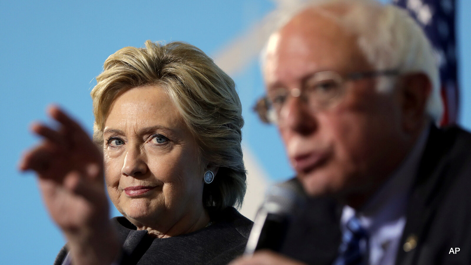 Democratic presidential candidate Hillary Clinton listens as Sen. Bernie Sanders, I-Vt. speaks during a campaign stop at the University Of New Hampshire in Durham, N.H., Wednesday, Sept. 28, 2016.