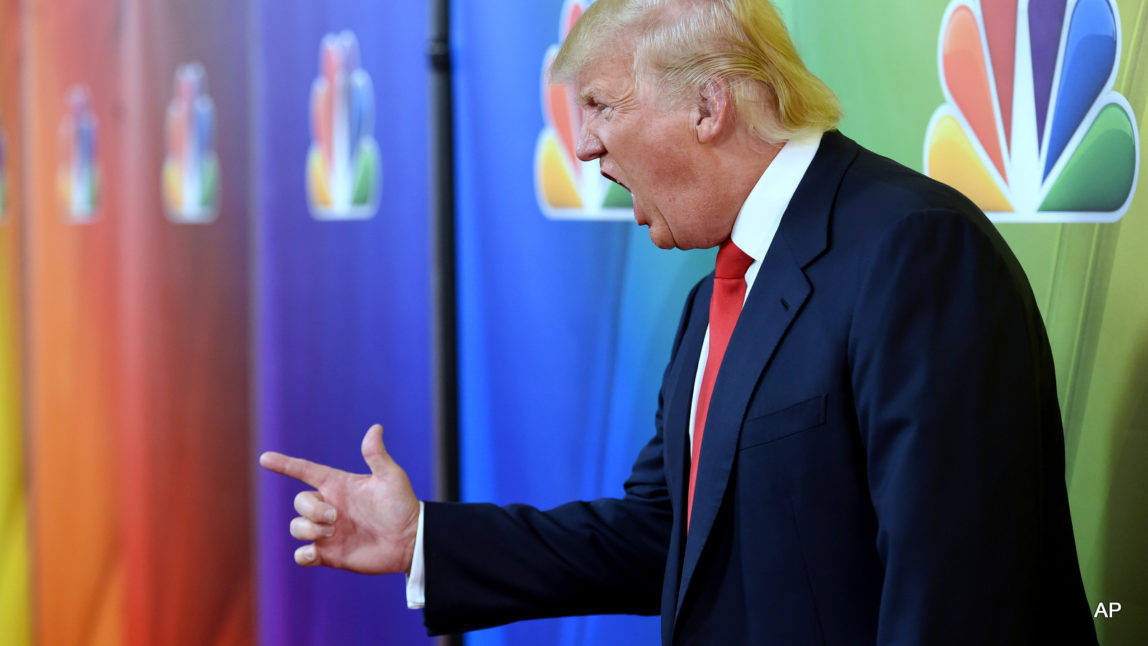 Donald Trump, host of the television series "The Celebrity Apprentice," mugs for photographers at the NBCUniversal 2015 Winter TCA Press Tour.