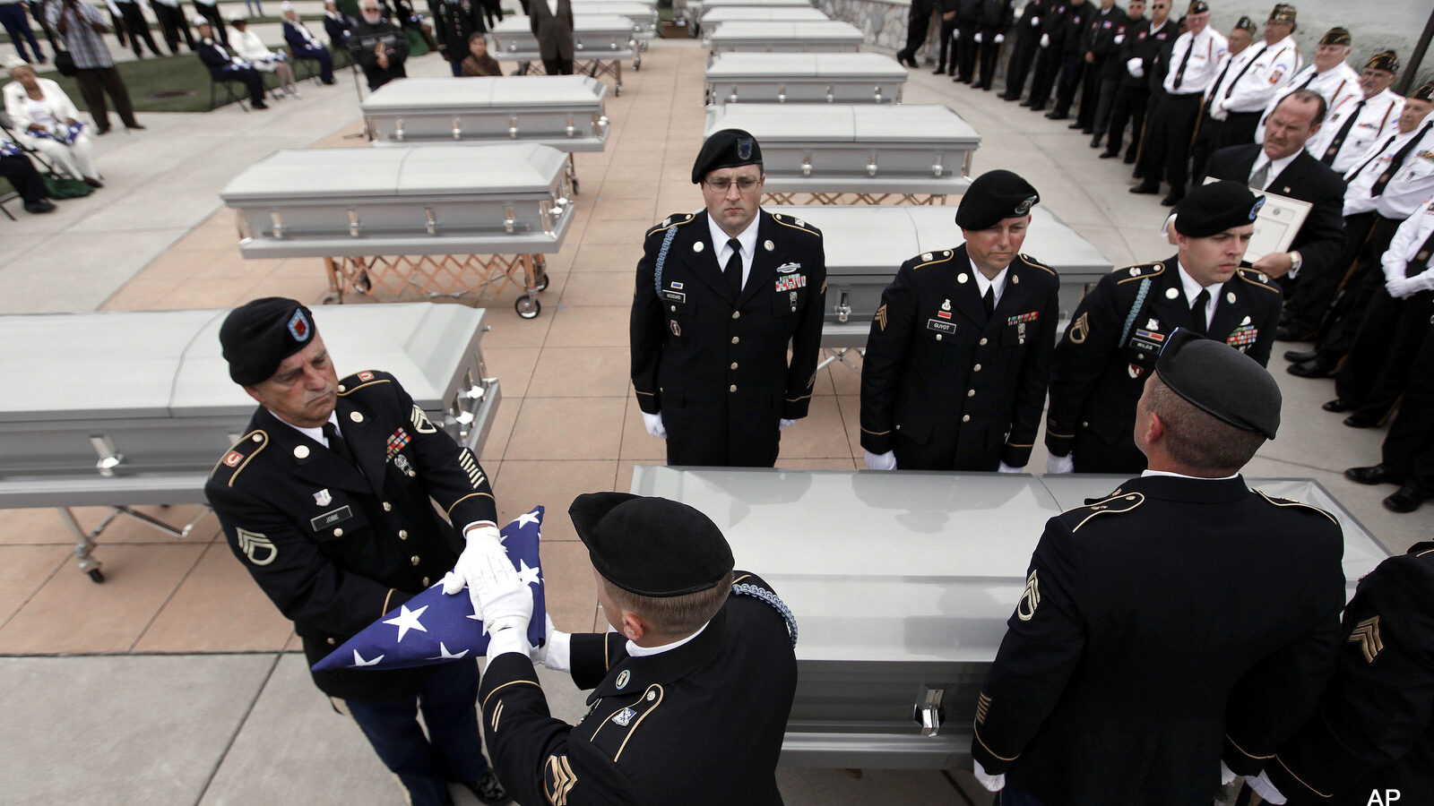 An Army honor guard prepare a folded a flag at a memorial service for veterans whose remains went unclaimed at a Detroit morgue.