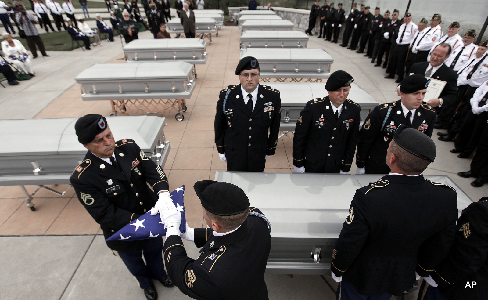 An Army honor guard prepare a folded a flag at a memorial service for veterans whose remains went unclaimed at a Detroit morgue.