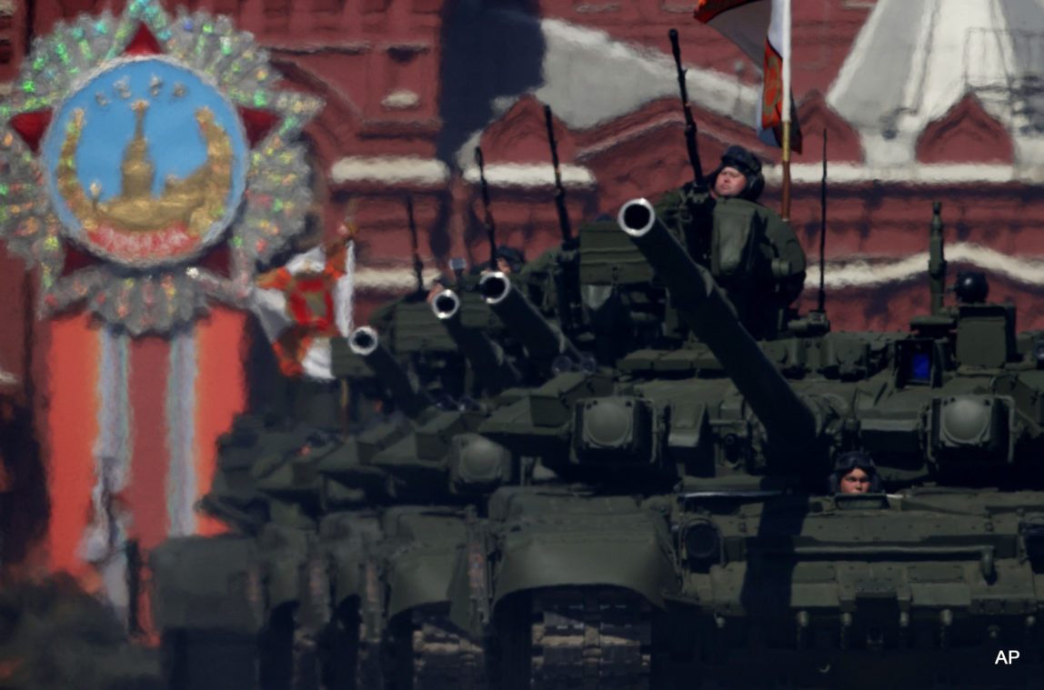 Russian army soldiers drive their tanks along the Red Square during a general rehearsal for the Victory Day military parade.
