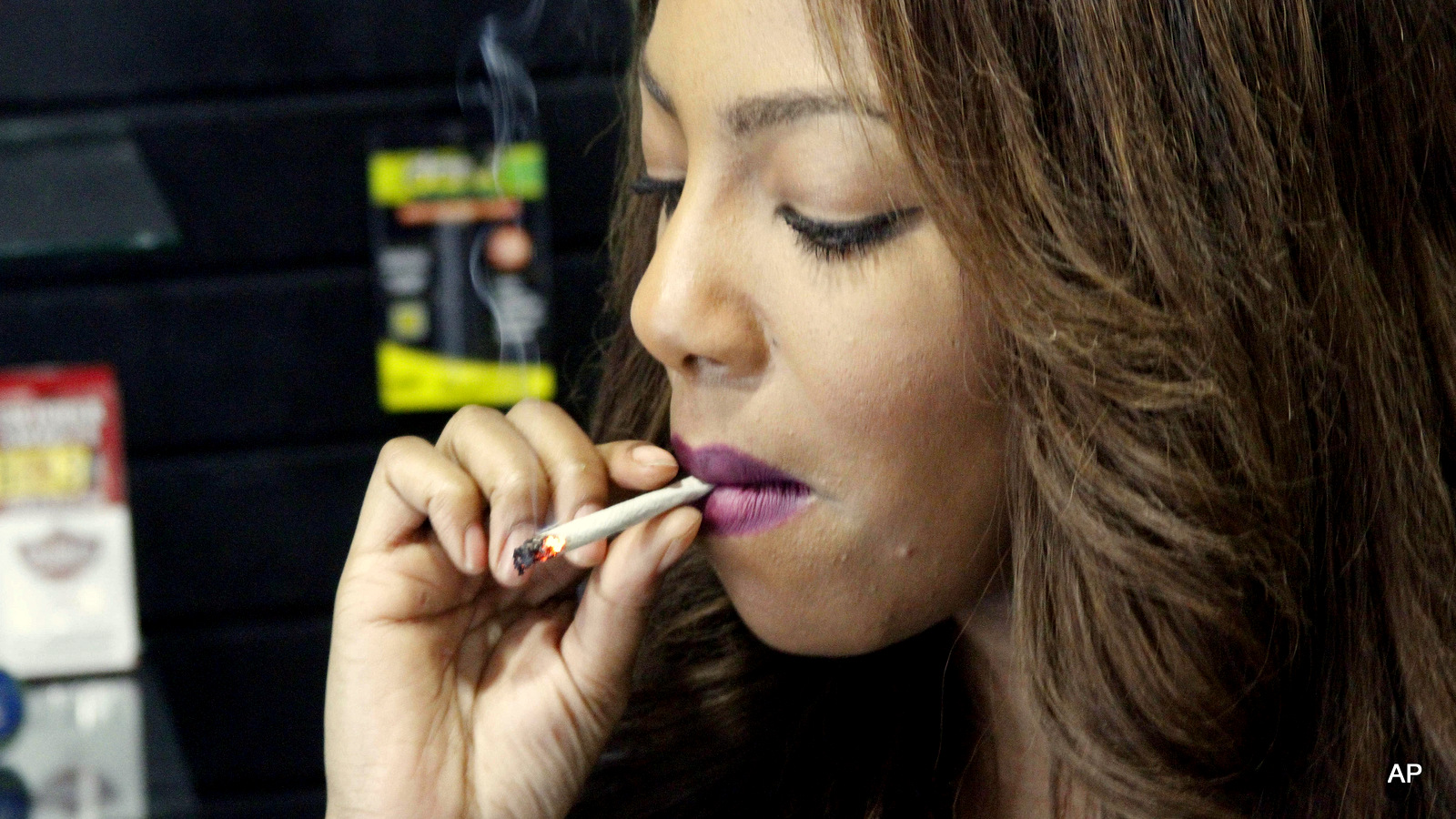 Former news anchor and Alaska Cannabis Club CEO Charlo Greene smokes a joint at the medical marijuana dispensary in Anchorage, Alaska. On Tuesday, Feb. 24, 2015,