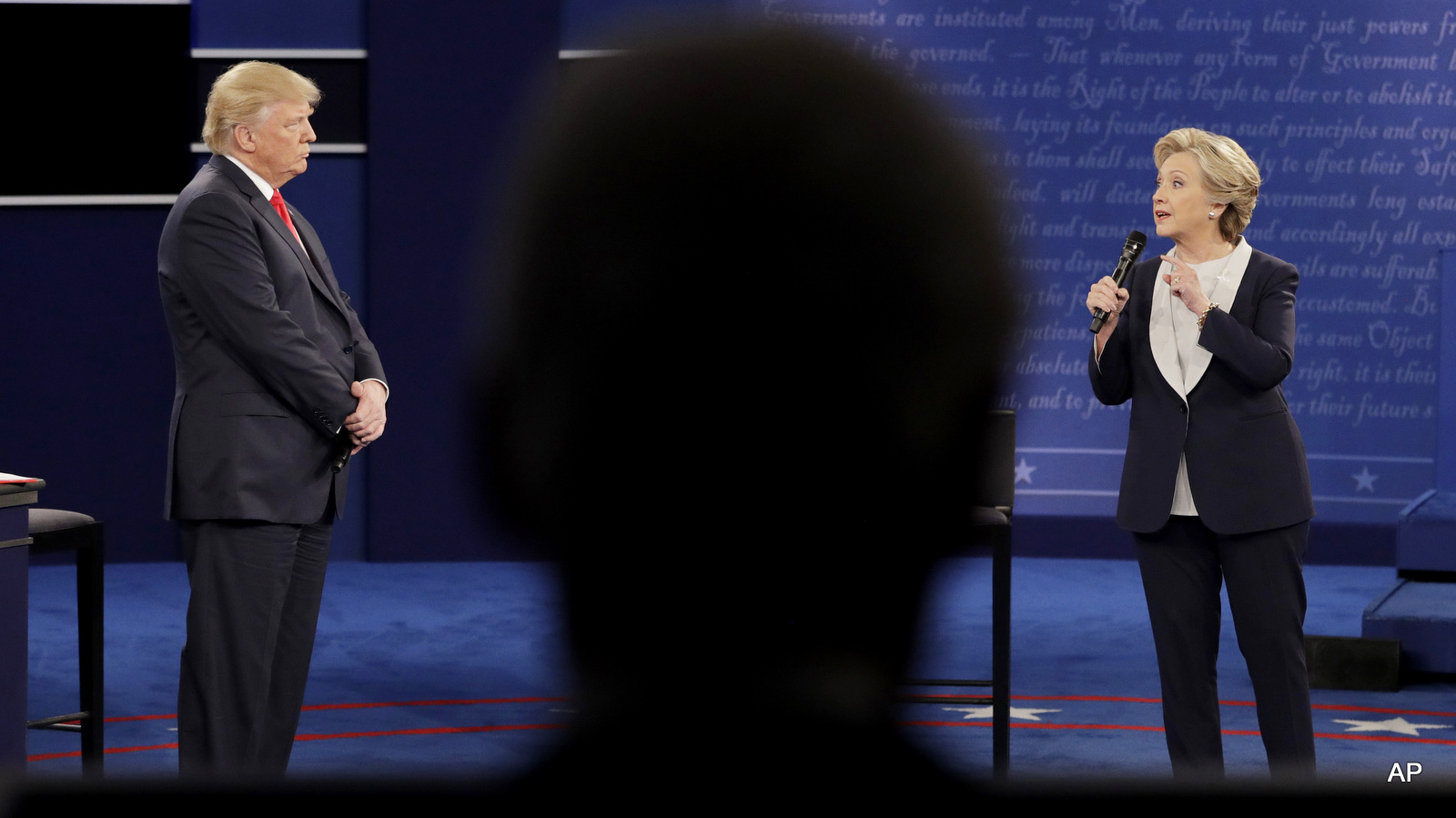 Bill Clinton, in foreground, watches the second presidential debate between Democratic presidential nominee Hillary Clinton and Republican presidential nominee Donald Trump at Washington University, Sunday, Oct. 9, 2016, in St. Louis.