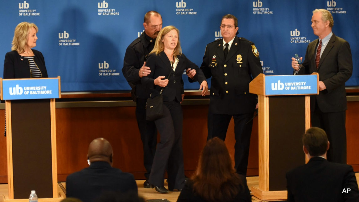 Margaret Flowers, center, the Green Party candidate for U.S. Senate in Maryland, is escorted off stage after interrupting a televised Senate debate between Rep. Kathy Szeliga, R-Baltimore County, left, and Rep. Chris Van Hollen, D-Md., in Baltimore, Wednesday, Oct. 26, 2016