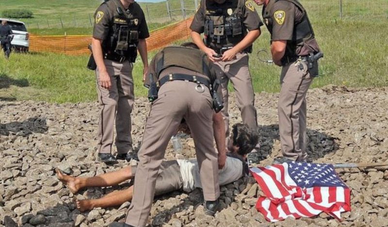 A protesters is arrested by police near the Dakota Access pipeline at a construction site in North Dakota, Oct. 22, 2016. (Photo: YouTube)