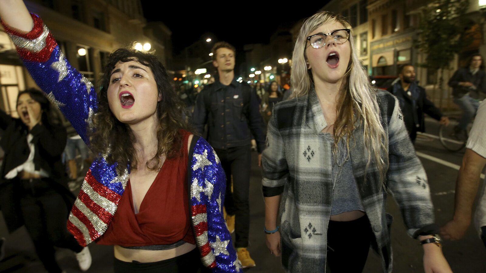 Madeline Lopes, left, and Cassidy Irwin, both of Oakland, march with other protesters in downtown Oakland, Calif., early Wednesday, Nov. 9, 2016. President-elect Donald Trump’s victory set off multiple protests. (Jane Tyska/Bay Area News Group via AP)