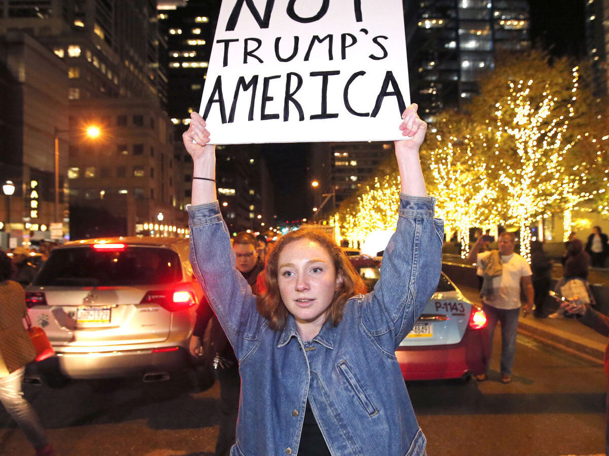 A protesters unhappy with the presidential election blocks traffic on JFK Blvd. as they march between cars on Thursday, Nov. 10, 2016, in Philadelphia. (Charles Fox/The Philadelphia Inquirer via AP)