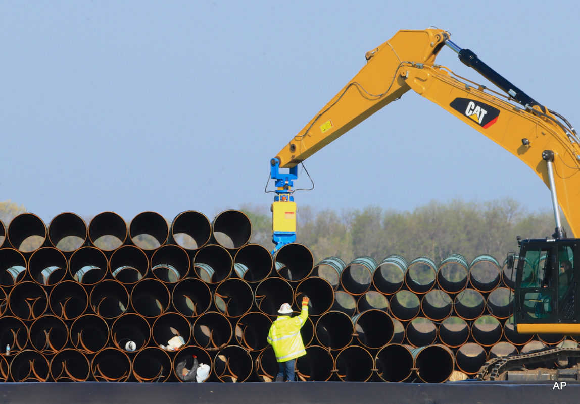 FILE - In this May 9, 2015 file photo, pipes for the proposed Dakota Access oil pipeline, that would stretch from the Bakken oil fields in North Dakota to Illinois, are stacked at a staging area in Worthing, S.D.