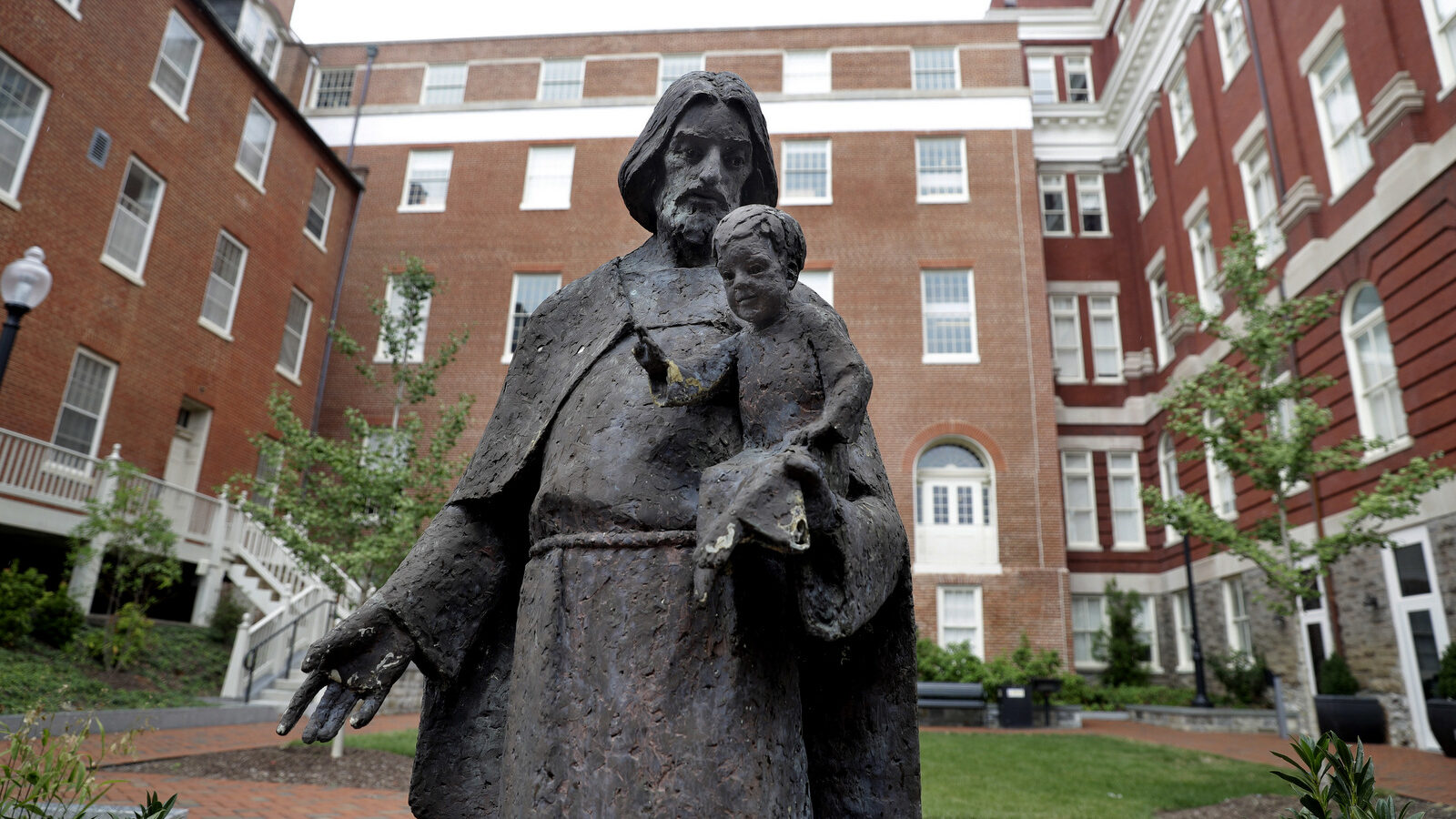 A Jesuit statue is seen in front of Freedom Hall, formerly named Mulledy Hall, on the Georgetown University campus, Thursday, Sept. 1, 2016, in Washington. (AP Photo/Jacquelyn Martin)