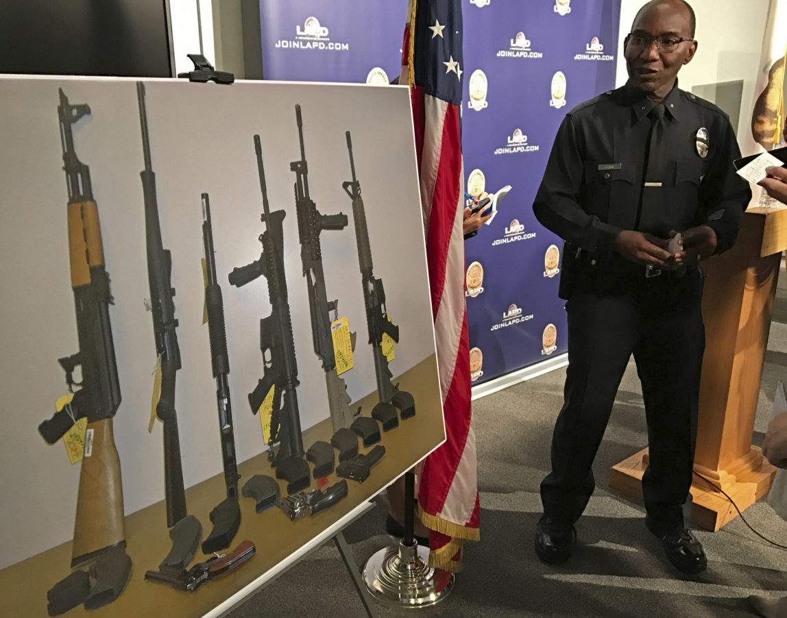 Los Angeles Police Cmdr. Horace Frank, right, shows a photo of multiple weapons found in the home of a man charged with making terrorist threats to the Islamic Center of Southern California, during a police news conference Tuesday, Oct. 25, 2016 in Los Angeles. Mark Lucian Feigin was arrested last week on the charge, which has been designated as a hate crime, according to authorities. Feigin, 40, has been released on bail. Police say Feigin first called the Islamic center Sept. 19 and left a hate-filled voicemail. The next day, they say, he called and threatened to kill people at the center. (AP Photo/Damian Dovarganes)Los Angeles Police Cmdr. Horace Frank, right, shows a photo of multiple weapons found in the home of a man charged with making terrorist threats to the Islamic Center of Southern California, during a police news conference Tuesday, Oct. 25, 2016 in Los Angeles. Mark Lucian Feigin was arrested last week on the charge, which has been designated as a hate crime, according to authorities. Feigin, 40, has been released on bail. Police say Feigin first called the Islamic center Sept. 19 and left a hate-filled voicemail. The next day, they say, he called and threatened to kill people at the center. (AP Photo/Damian Dovarganes)