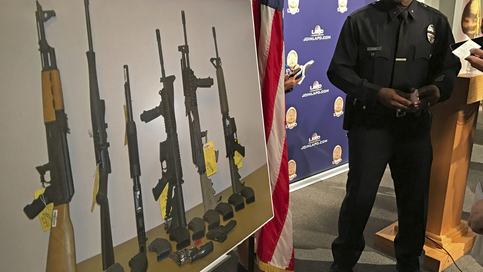 Los Angeles Police Cmdr. Horace Frank, right, shows a photo of multiple weapons found in the home of a man charged with making terrorist threats to the Islamic Center of Southern California, during a police news conference Tuesday, Oct. 25, 2016 in Los Angeles. Mark Lucian Feigin was arrested last week on the charge, which has been designated as a hate crime, according to authorities. Feigin, 40, has been released on bail. Police say Feigin first called the Islamic center Sept. 19 and left a hate-filled voicemail. The next day, they say, he called and threatened to kill people at the center. (AP Photo/Damian Dovarganes)Los Angeles Police Cmdr. Horace Frank, right, shows a photo of multiple weapons found in the home of a man charged with making terrorist threats to the Islamic Center of Southern California, during a police news conference Tuesday, Oct. 25, 2016 in Los Angeles. Mark Lucian Feigin was arrested last week on the charge, which has been designated as a hate crime, according to authorities. Feigin, 40, has been released on bail. Police say Feigin first called the Islamic center Sept. 19 and left a hate-filled voicemail. The next day, they say, he called and threatened to kill people at the center. (AP Photo/Damian Dovarganes)