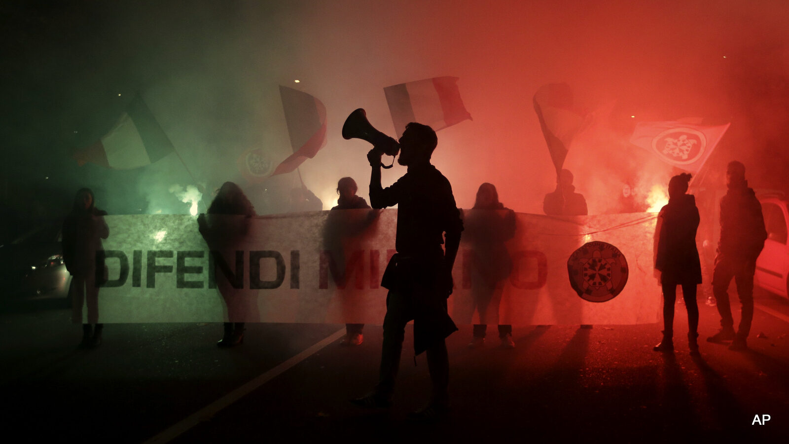 CasaPound right-wing demonstrators outside the former Montello barracks, where migrants are being transferred by Milan's prefecture, in Milan, Italy, Monday, Oct. 31, 2016.