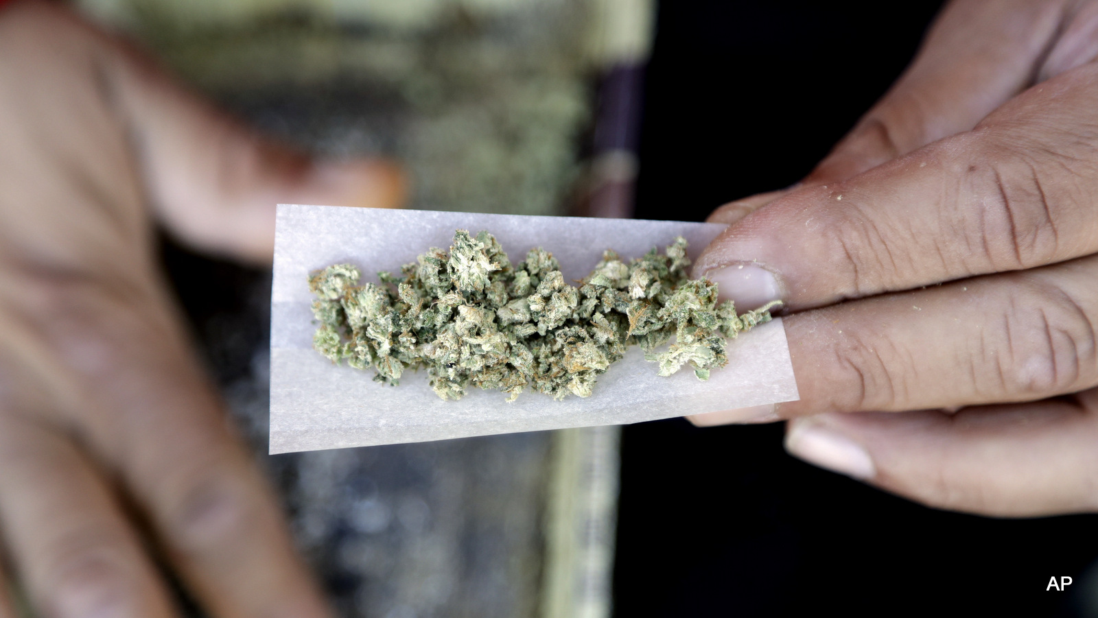 A marijuana joint is rolled Wednesday, Nov. 9, 2016, in San Francisco. Prop 64 legalizing marijuana for recreational use passed in California. The number of Americans living in states with recreational marijuana more than tripled after at least three states voted to fully legalize the drug.