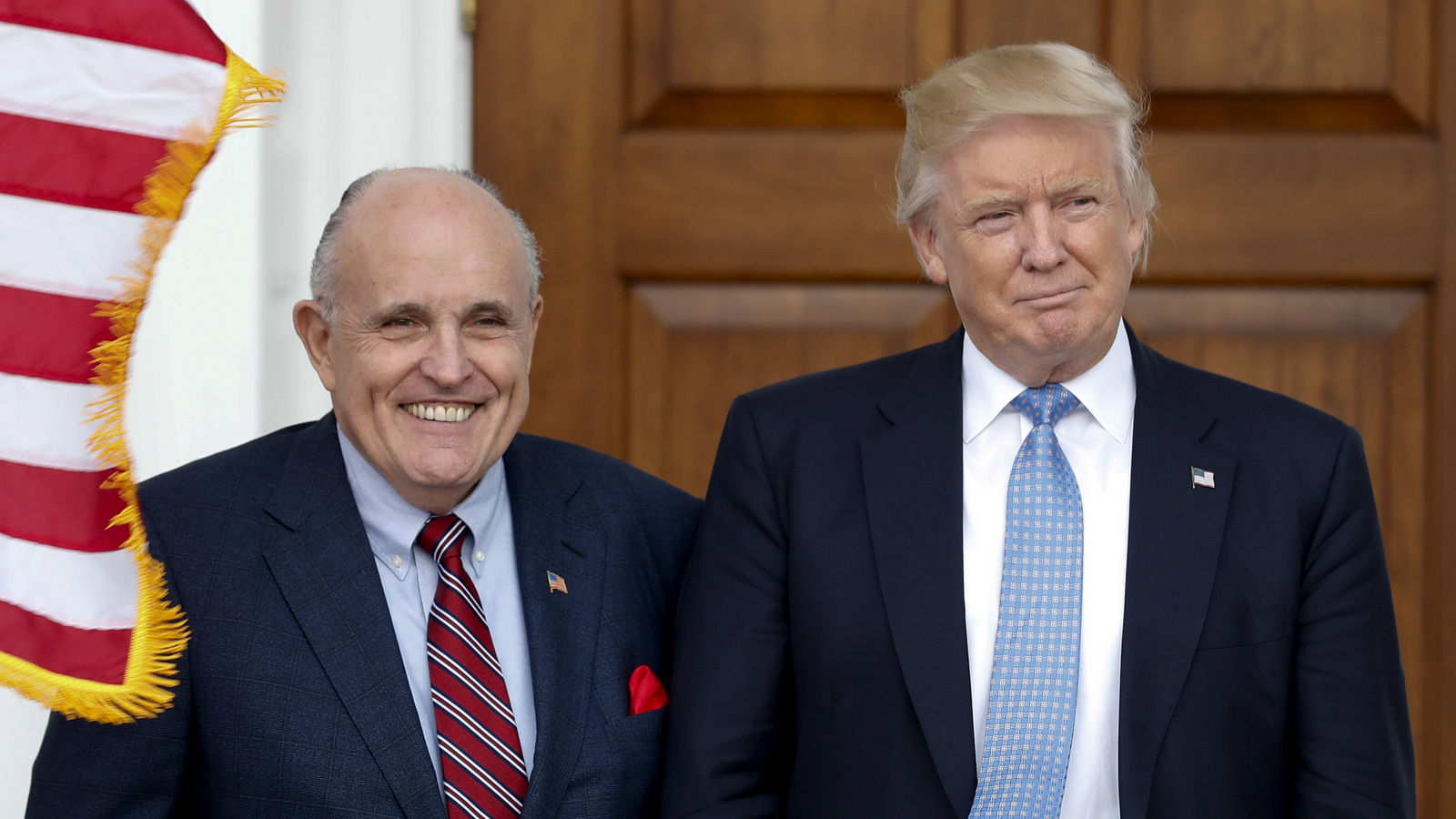 President-elect Donald Trump, right, and former New York Mayor Rudy Giuliani pose for photographs as Giuliani arrives at the Trump National Golf Club Bedminster clubhouse, Sunday, Nov. 20, 2016, in Bedminster, N.J.. (AP Photo/Carolyn Kaster)