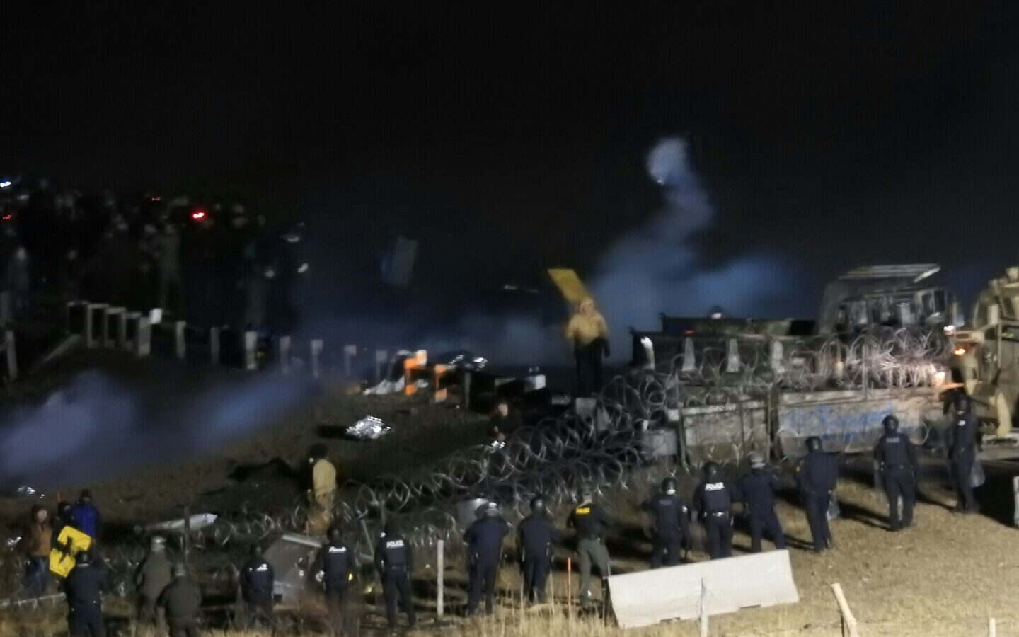 In this image provided by Morton County Sheriff’s Department, law enforcement and protesters clash near the site of the Dakota Access pipeline on Sunday, Nov. 20, 2016, in Cannon Ball, N.D. (Morton County Sheriff’s Department via AP)