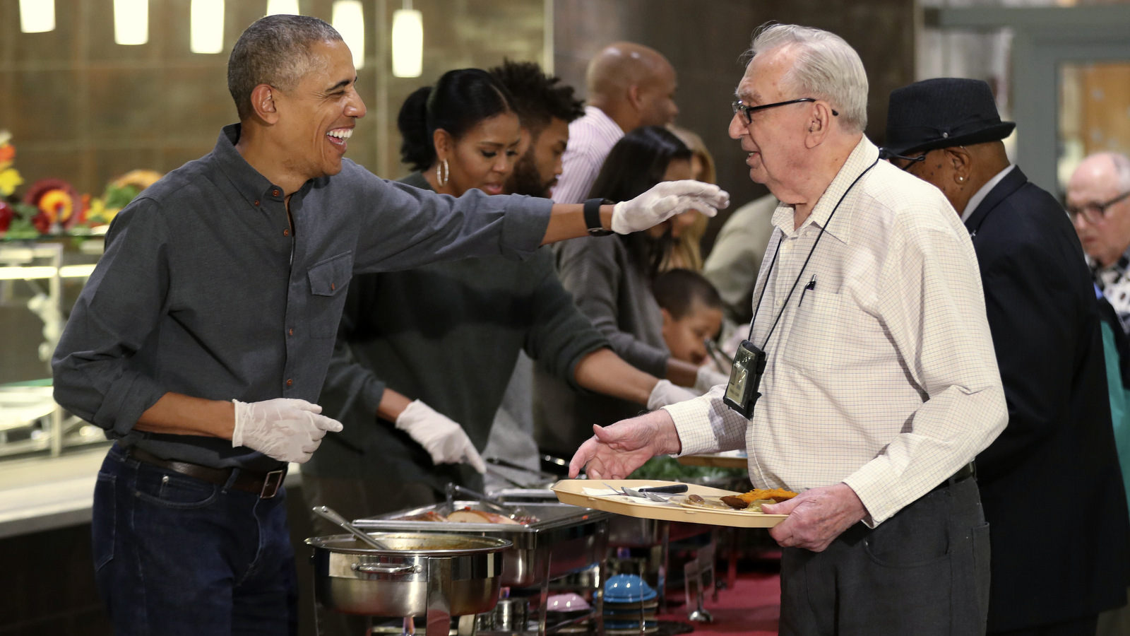 President Barack Obama with first lady Michelle Obama and some relatives serve Thanksgiving meals to residents of the Armed Forces Retirement Home, in Washington, Wednesday, Nov. 23, 2016. (AP Photo/Manuel Balce Ceneta)