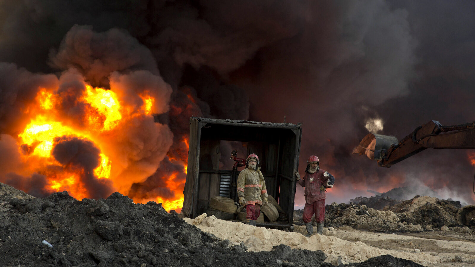 Iraqi fire fighters work to quell a dangerous oil fire set by ISIS militants in Qayara, south of Mosul, Iraq, Monday, Nov. 28, 2016. (AP Photo/Maya Alleruzzo)