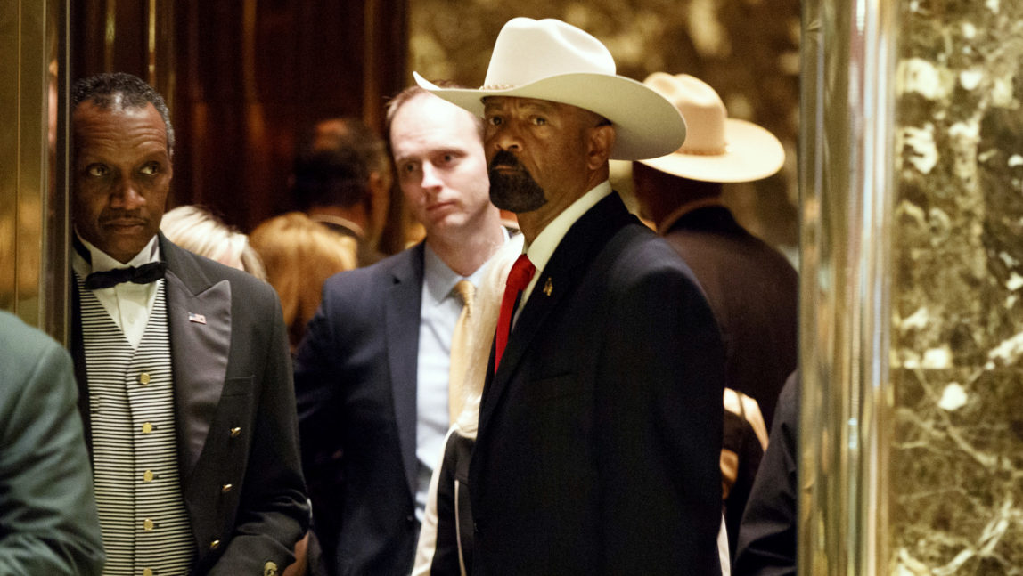 Notorious Milwaukee Sheriff David Clarke gets on an elevator after arriving at Trump Tower, Monday, Nov. 28, 2016, in New York. (AP Photo/Evan Vucci)