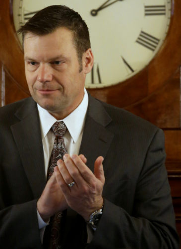 In this Monday, Jan. 12, 2015 photo, Kansas Secretary of State Kris Kobach presides over the Kansas House while new members are sworn in during the opening day of the Kansas legislature in Topeka, Kan. (AP Photo/Charlie Riedel, File)
