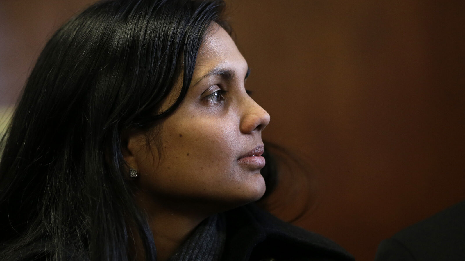 Annie Dookhan sits in Suffolk Superior Court moments before her arraignment in Boston, Thursday, Dec. 20, 2012. Dookhan, the former chemist at the center of a U.S. drug testing scandal, pleaded not guilty to charges including perjury and tampering with evidence.