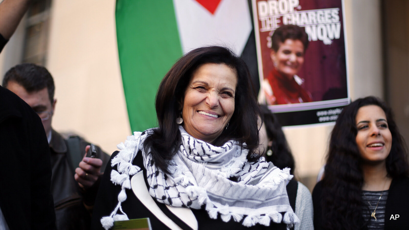 Rasmea Odeh smiles after leaving federal court in Detroit Thursday, March 12, 2015. A judge sentenced the Chicago activist to 18 months in federal prison Thursday for failing to disclose her convictions for bombings in Israel when she applied to be a U.S. citizen. Odeh, 67, also was stripped of her citizenship and eventually will be deported. But she will remain free while she appeals the case.