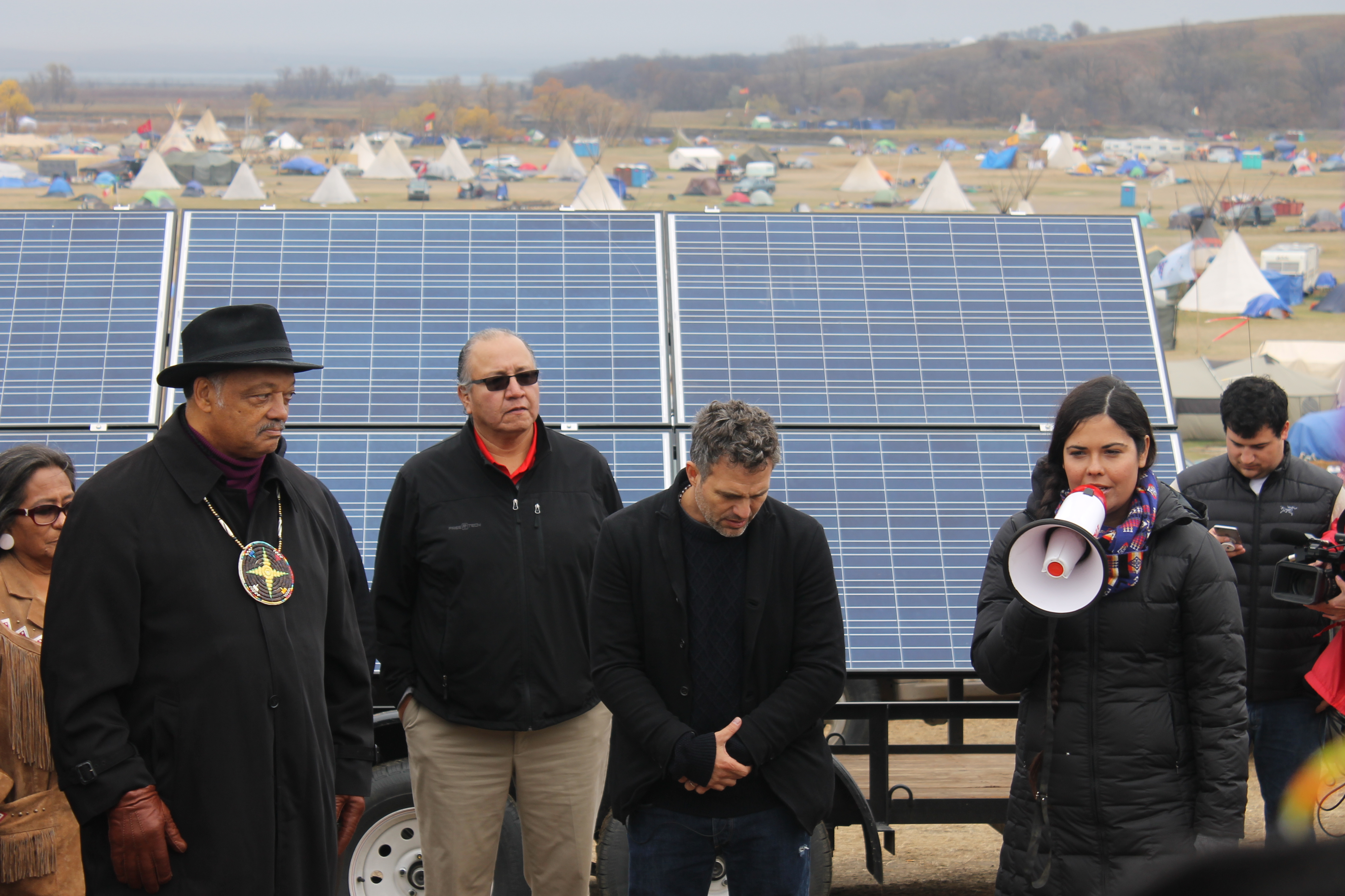 The Rev. Jesse Jackson stands with Mark Ruffalo, actor and co-founder of the Solutions Project, which donated solar panels on trailers to the Standing Rock Sioux tribal elders. Oct. 26, 2016 (Derrick Broze for MintPress)