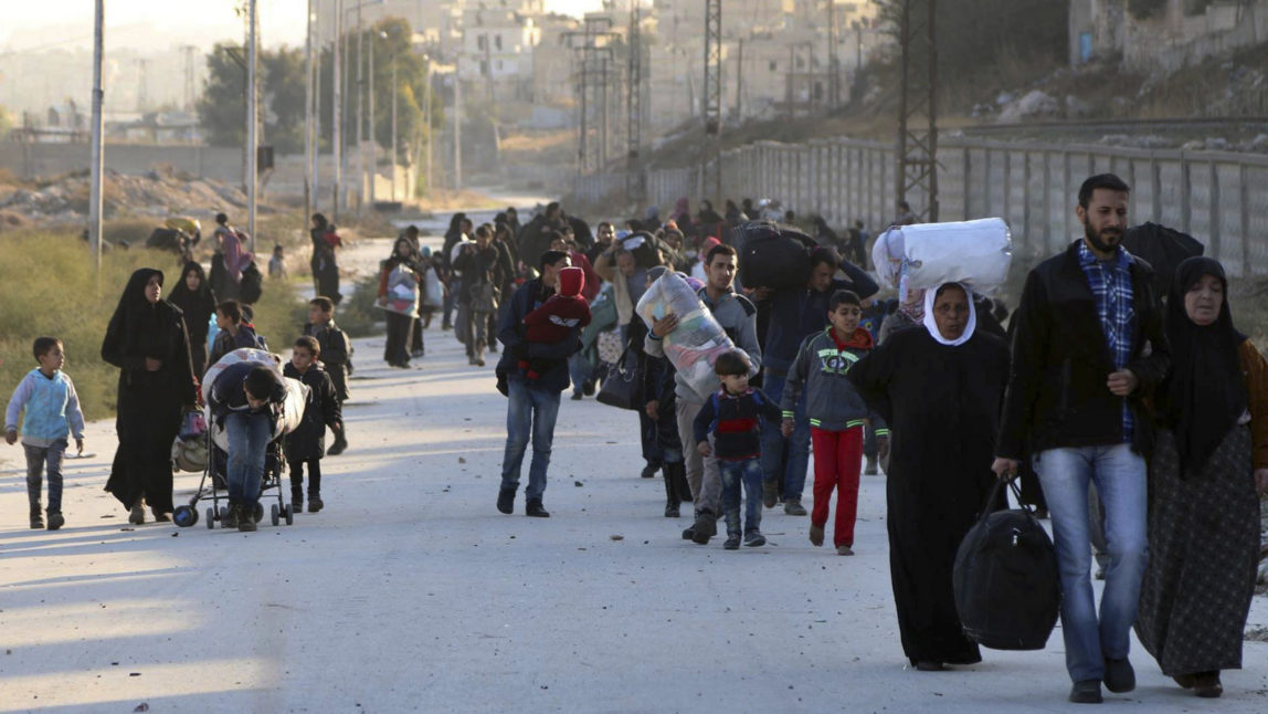 Residents fleeing rebel-held eastern neighborhoods of Aleppo into the Sheikh Maqsoud area, Syria. (The Rumaf via AP)