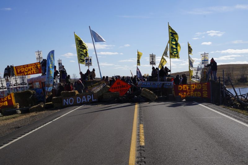 Water protectors block North Dakota Highway 1806 at the site of the frontline camp, just north of Red Warrior Camp near the Standing Rock Sioux Reservation which straddles the border of North and South Dakota. The water protectors established the frontline camp to halt construction on the Dakota Access pipeline. Oct. 26, 2016 (Derrick Broze for MintPress)