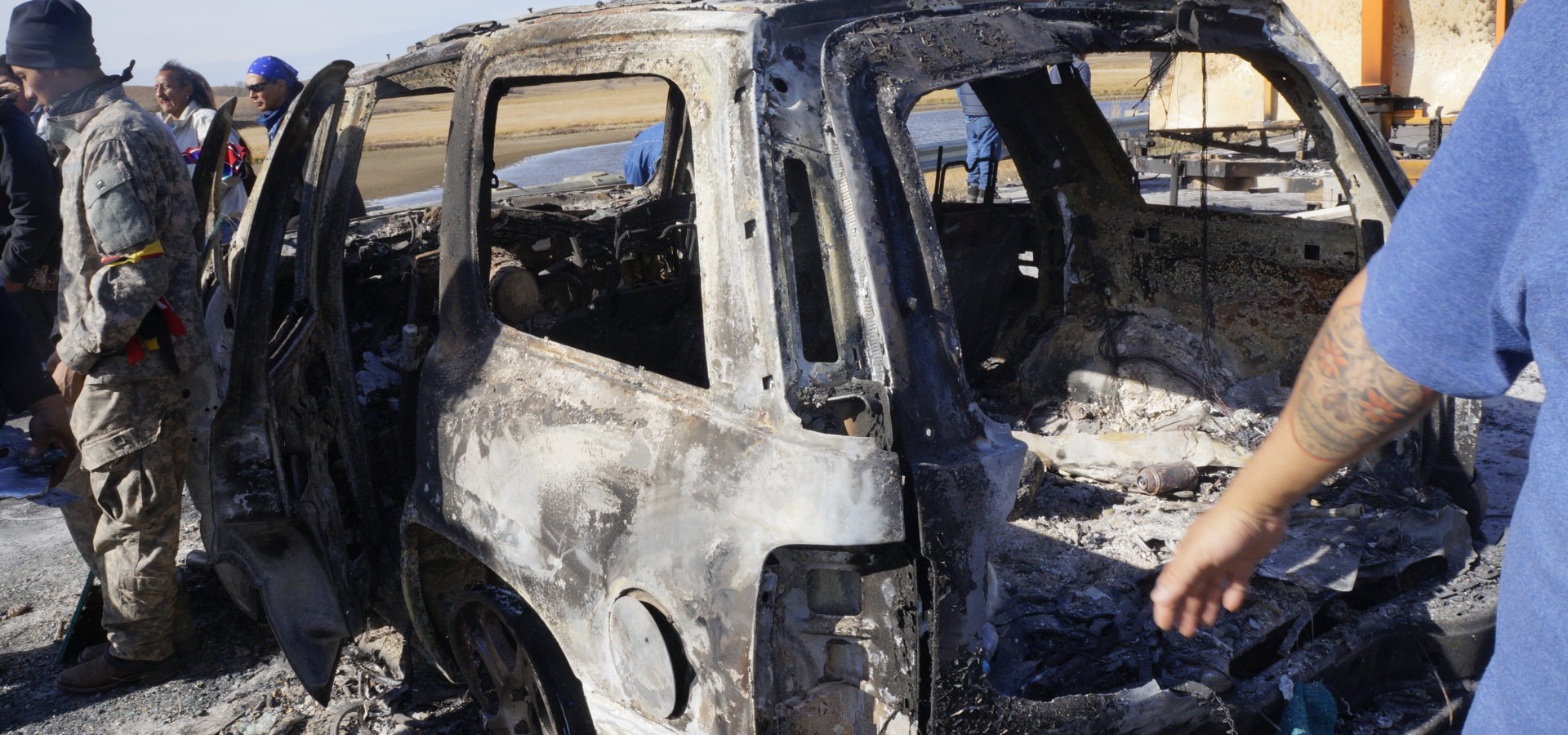 The remnants of a vehicle burned on North Dakota Highway 1806 on the night of Oct. 27, 2016. Non-peaceful forces embedded on the side of the water protectors were seen burning the vehicle and two armored vehicles over the protests of water protectors. (Derrick Broze for MintPress)