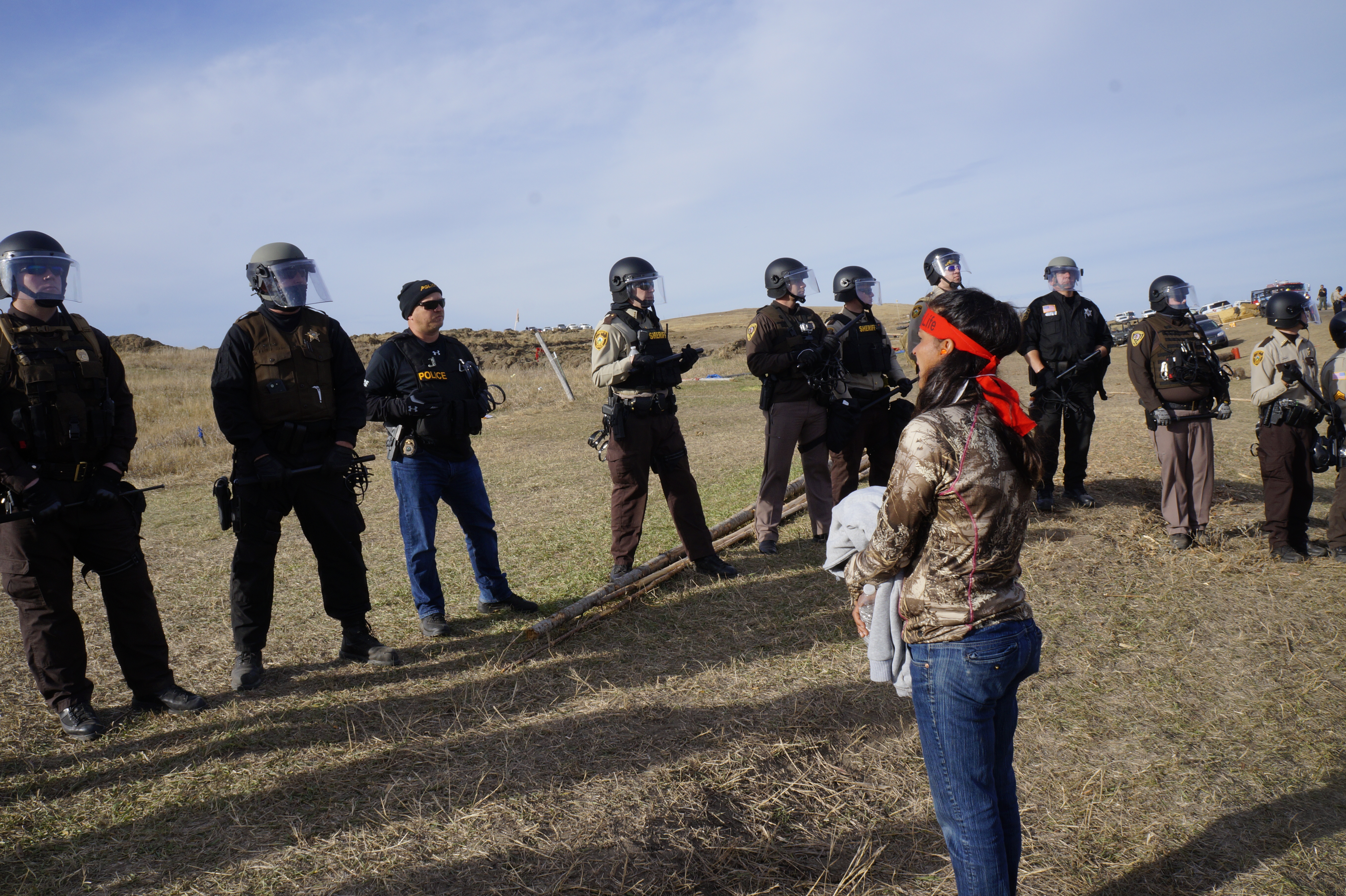 A water protector stares down police off highway 134, October 27. (Photo: Derrick Broze)