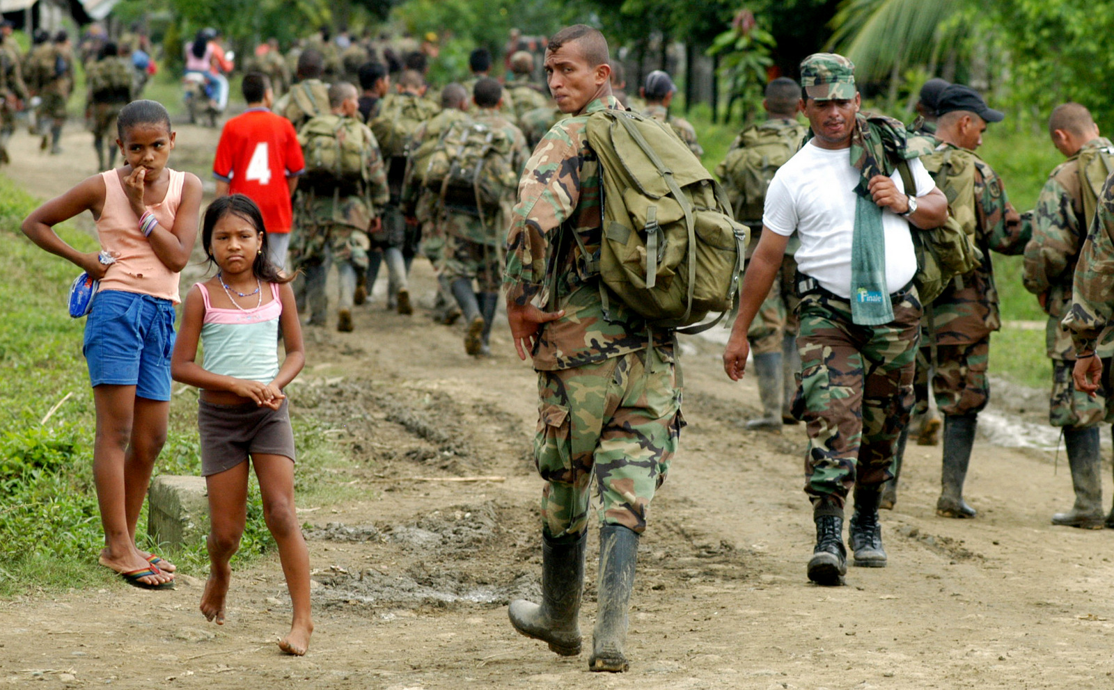 In this photograph provided by the El Tiempo newspaper, paramilitary fighters of the "Banana Bloc", known as the United Self-Defense Forces of Colombia, or AUC arrive at a rural area outside of the northwestern Colombian town of Turbo, Nov. , 2004. (AP/Julio Cesar Herrera/El Tiempo)