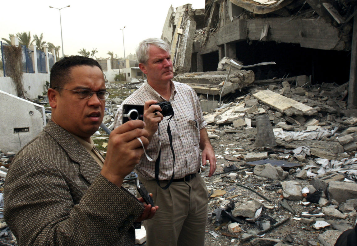 U.S. Rep. Keith Ellison, D-Minn., left and U.S. Rep. Brian Baird, D-Wash., right, take photos of the rubble of the American International school in Beit Lahiya in the northern of Gaza Strip, Thursday, Feb. 19, 2009. (AP Photo/Adel Hana)