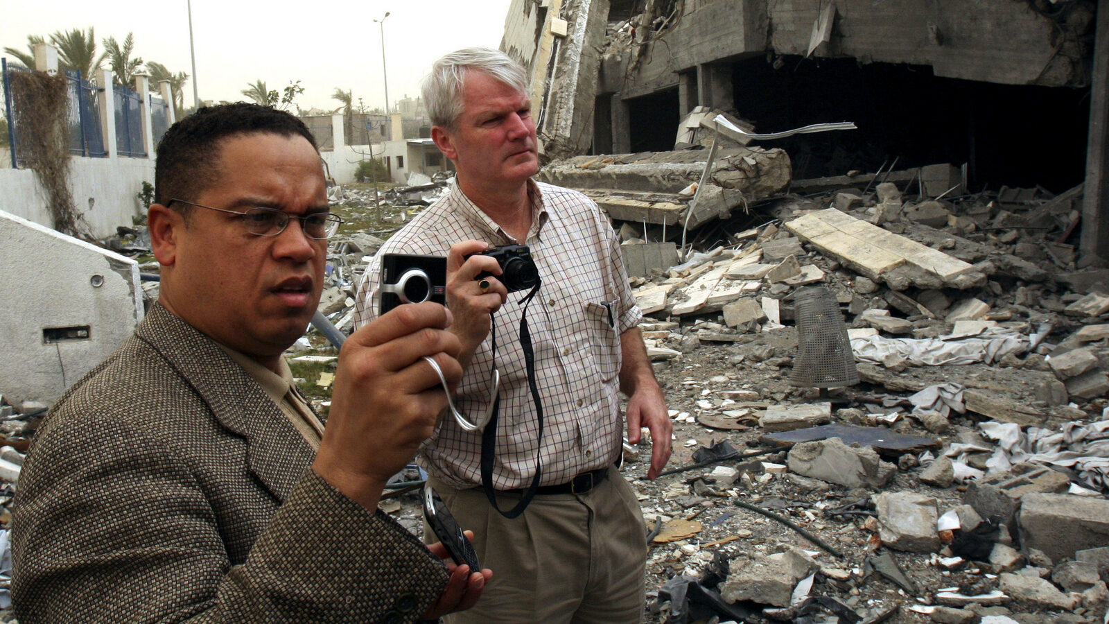 U.S. Rep. Keith Ellison, D-Minn., left and U.S. Rep. Brian Baird, D-Wash., right, take photos of the rubble of the American International school in Beit Lahiya in the northern of Gaza Strip, Thursday, Feb. 19, 2009. (AP Photo/Adel Hana)