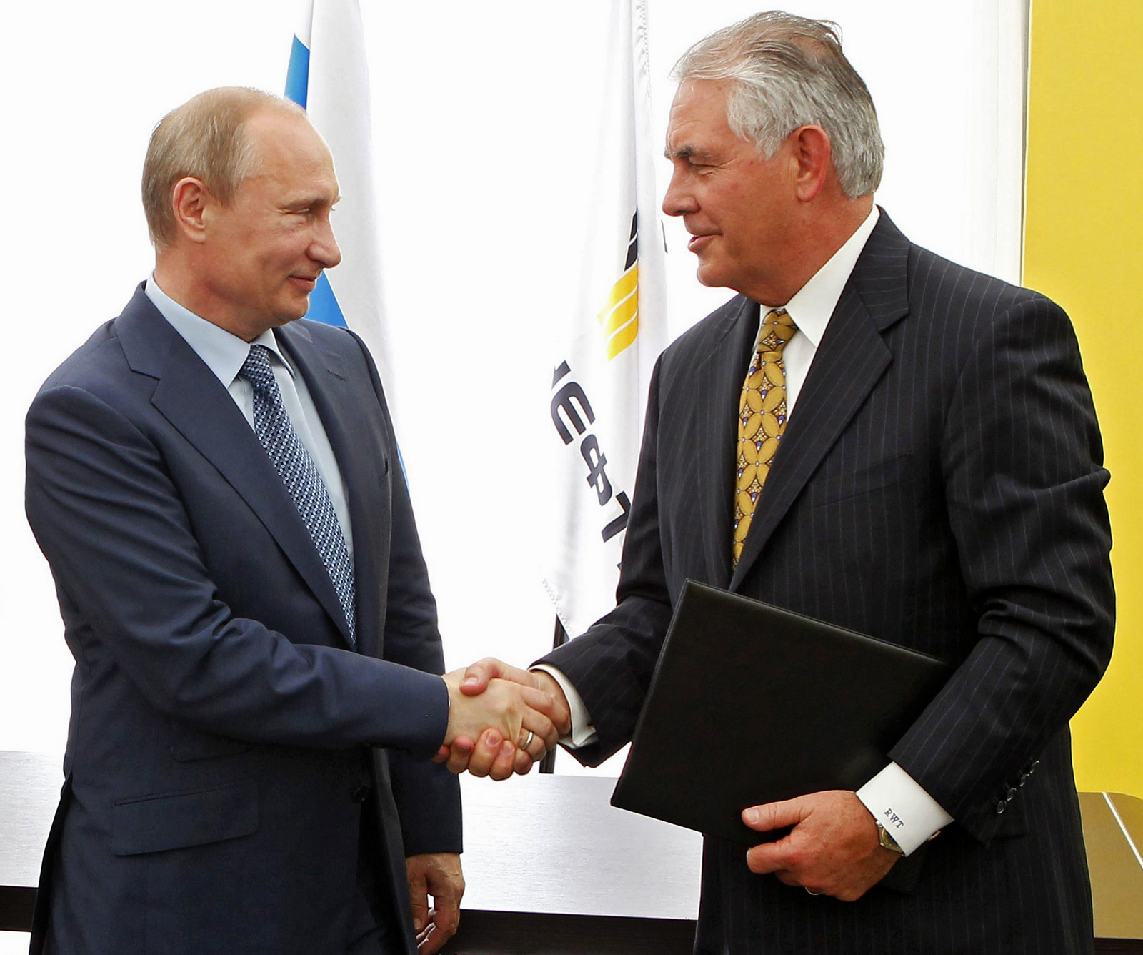 Russian President Vladimir Putin, left, and Exxon Mobil Corp. CEO Rex Tillerson shake hands at a signing ceremony of an agreement between state-controlled Russian oil company Rosneft and Exxon Mobil corporation at the Black Sea port of Tuapse, southern Russia, Friday, June 15, 2012. (AP Photo/RIA-Novosti, Mikhail Klimentyev, Presidential Press Service)