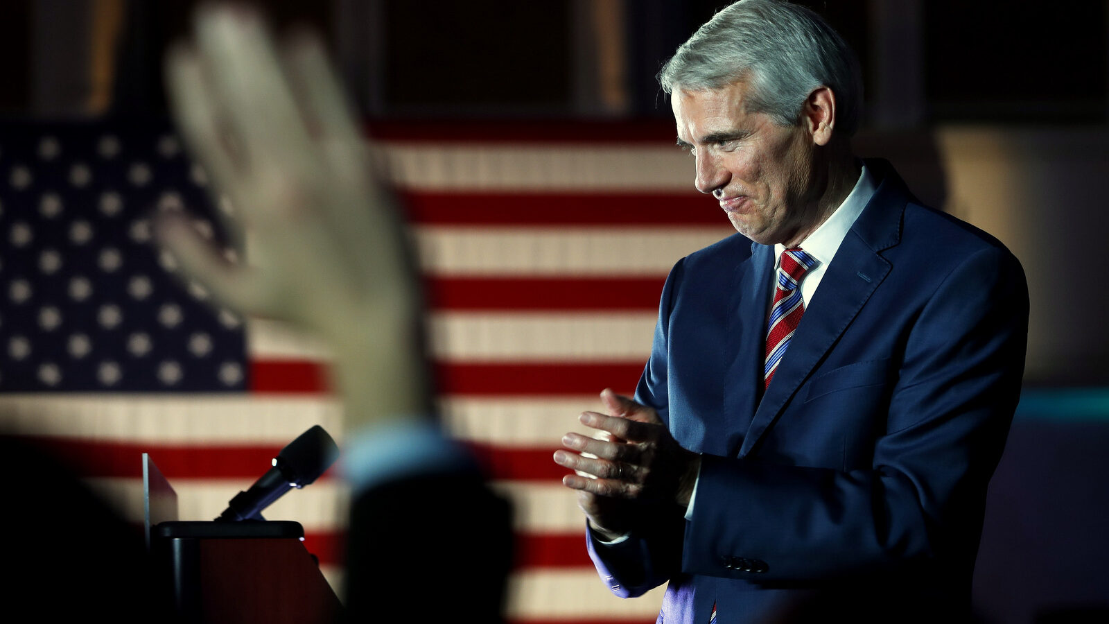 Sen. Rob Portman, R-Ohio smiles and applauds after winning re-election, Portman, along with Chris Murphy (D – CT) are behind a recent bill aimed at countering 'foreign propaganda'. (AP Photo/John Minchillo)