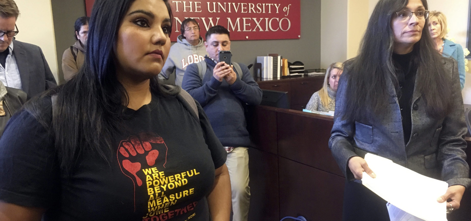 University of New Mexico student LuzHilda Campos, left, and Chicano studies professor Irene Vasquez, right, present a letter with hundreds of signatures on Friday, Nov. 18, 2016, to school president Bob Frank asking him to declare the campus a "sanctuary university," in Albuquerque, N.M.. (AP Photo/Russell Contreras)