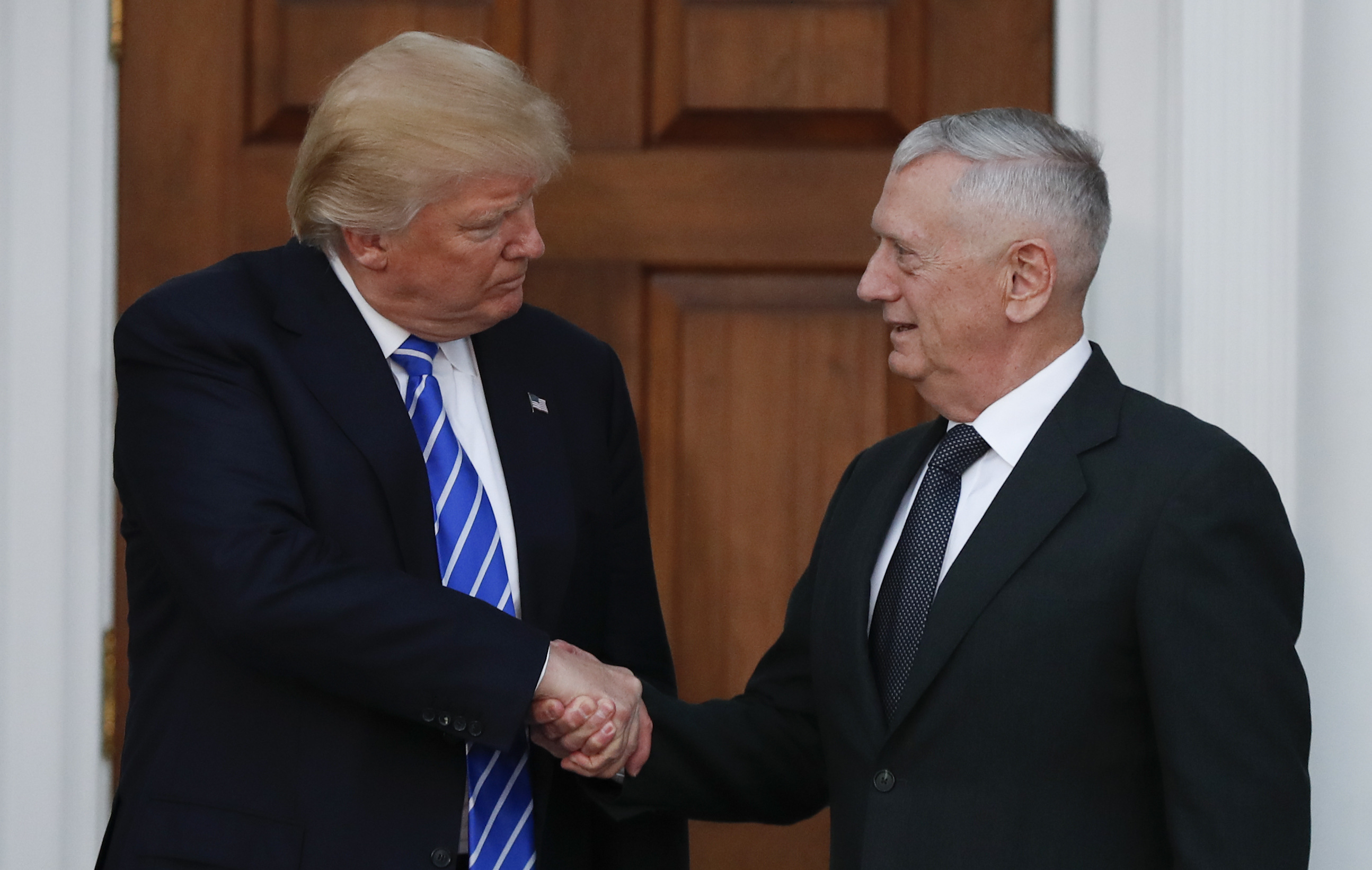 President-elect Donald Trump shakes hands with retired Marine Corps Gen. James Mattis as he leaves Trump National Golf Club Bedminster clubhouse in Bedminster, N.J., Saturday, Nov. 19, 2016. (AP Photo/Carolyn Kaster)